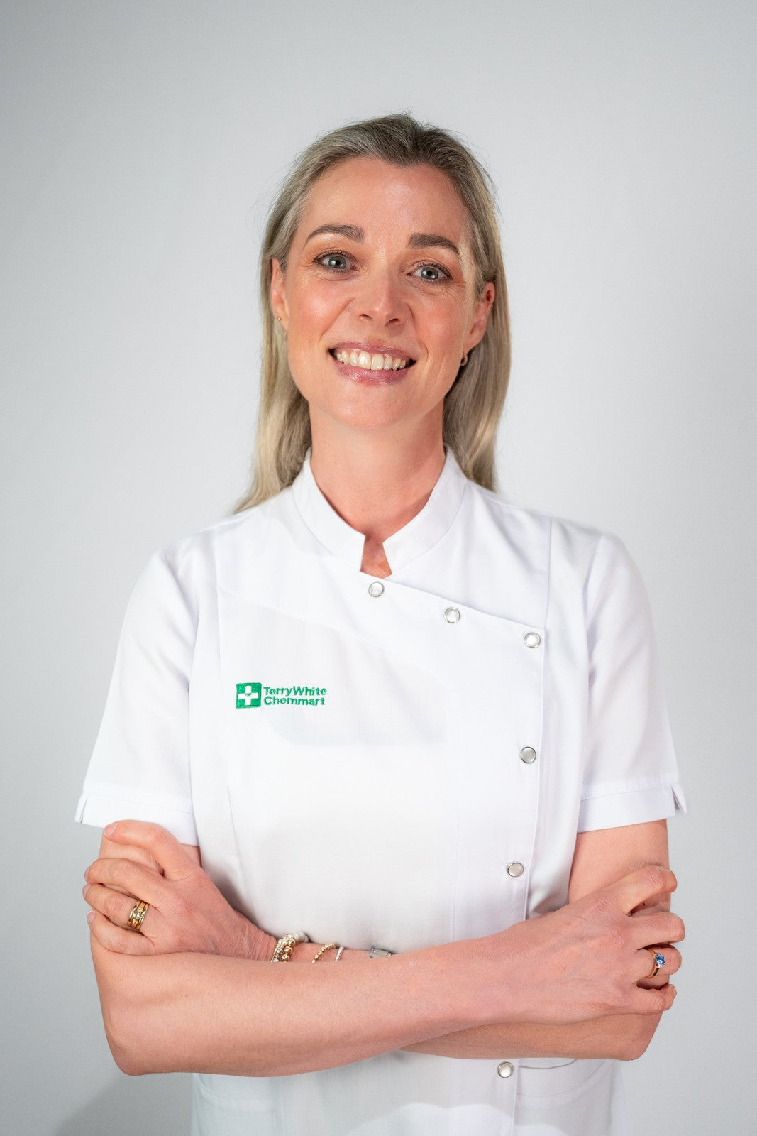 female wearing a white pharmacist jacket